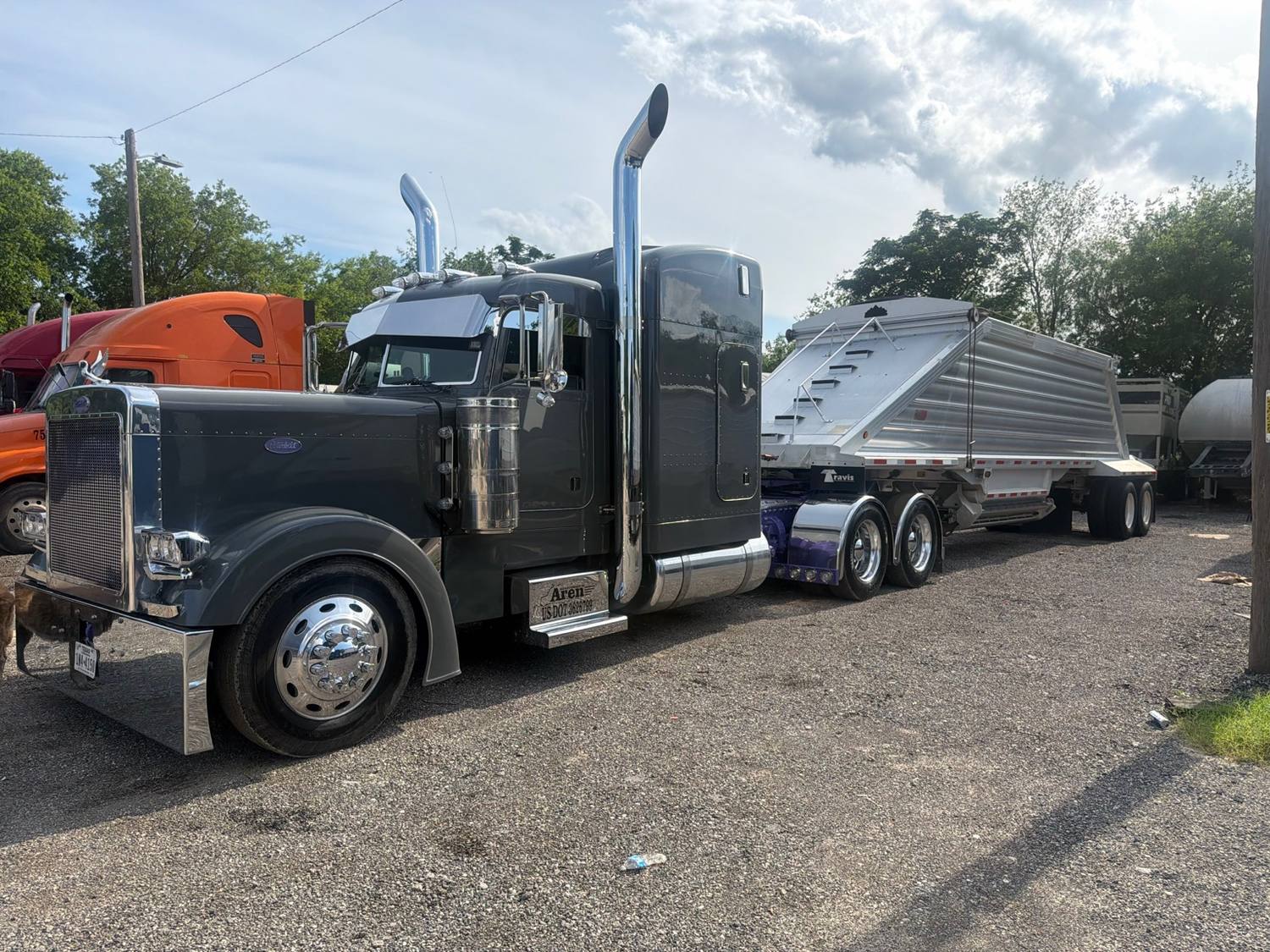 AREN Peterbilt tractor with hopper trailer staged in a South Texas yard